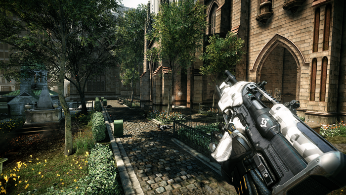 Assault rifle in a courtyard with a church