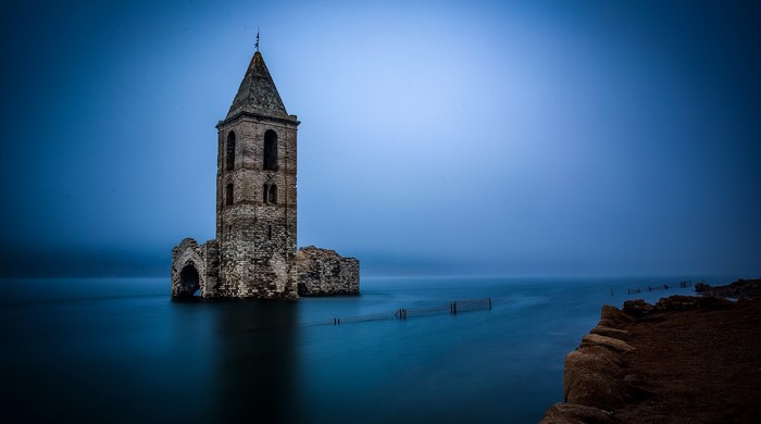 Ruined church tower submerged in water
