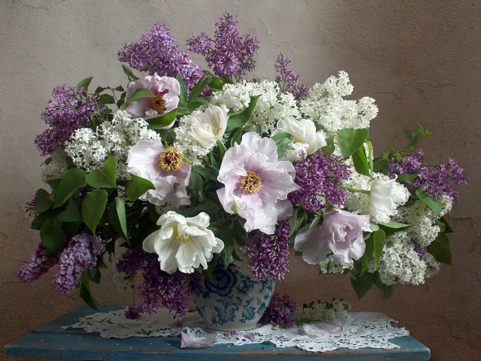 Still life of lilac and peony flowers in a vase