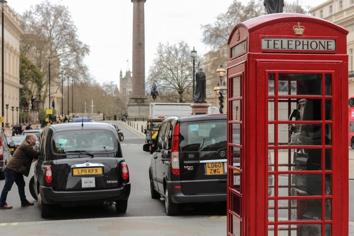 London street with red telephone booth and black cabs