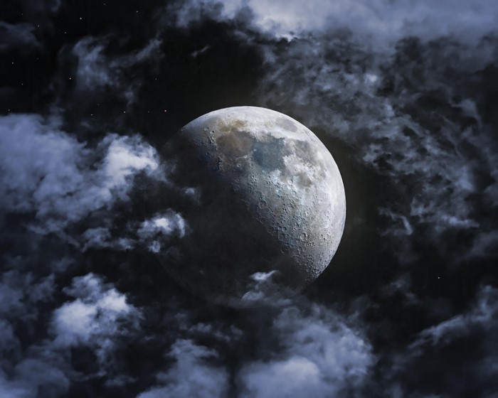 Moon through clouds in space