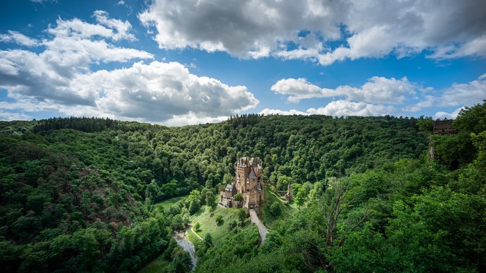 Castle Eltz in a German forest with clouds
