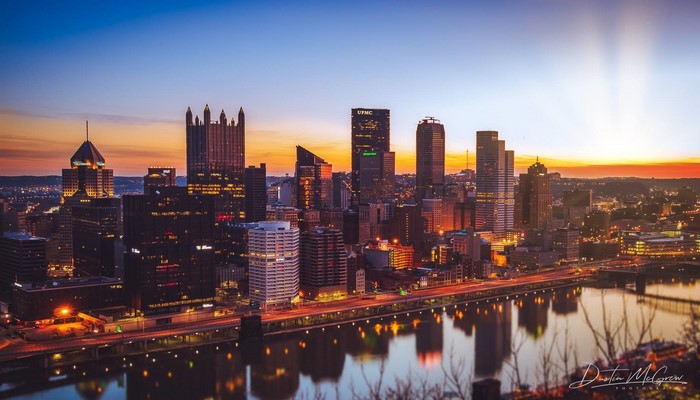 Pittsburgh skyline at sunset with river reflection