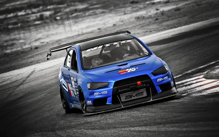 Blue Mitsubishi Lancer Evo X on a Racetrack