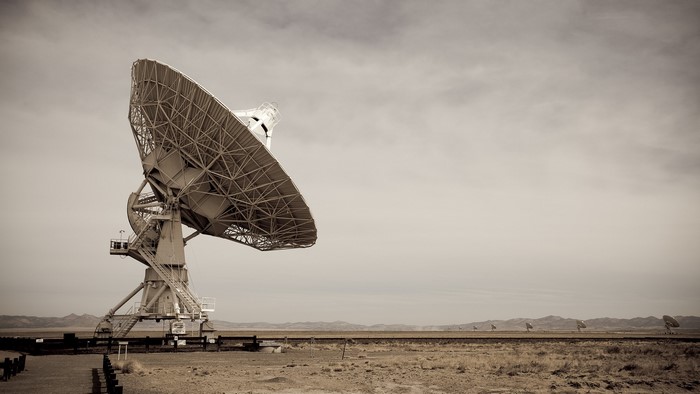 Radio telescope in a desert landscape