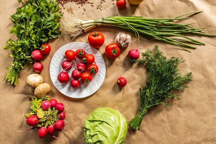 Fresh vegetables and mushrooms on a brown paper background