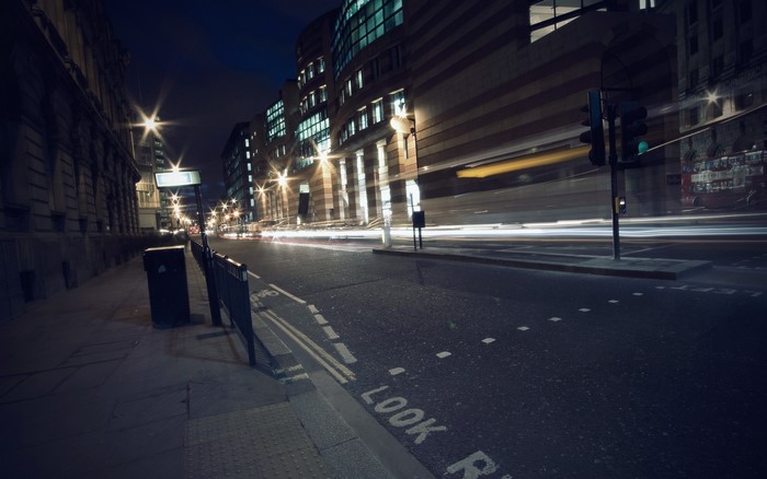 Night street with light trails and traffic lights