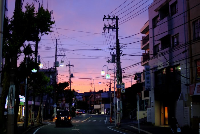 Street scene in Japan at dusk with purple sky