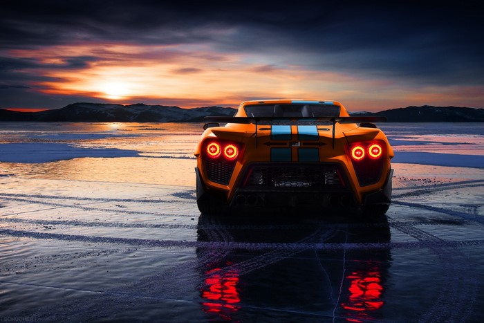 Orange Zenvo ST1 hypercar on ice at sunset