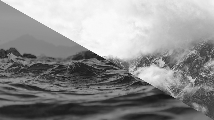 Monochrome image of ocean waves and misty mountains