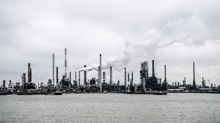 Industrial refinery with smoke stacks by the water