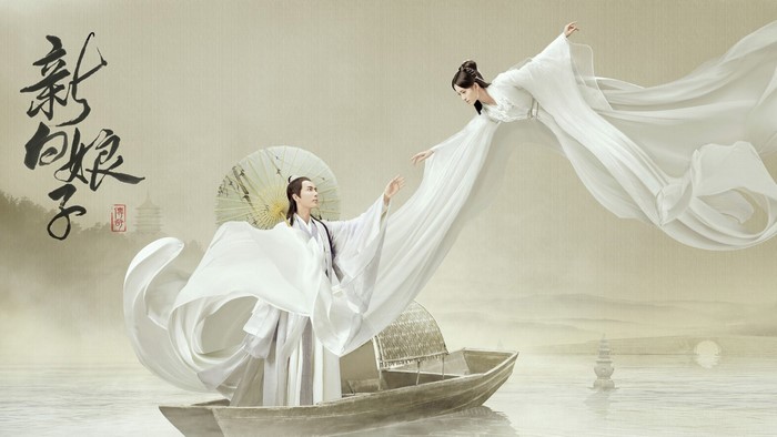Couple in white robes reaching for each other