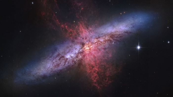 M82 galaxy with red and blue gas clouds
