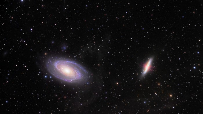 Two galaxies in deep space with stars