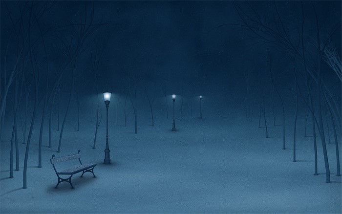 Snowy park at night with streetlights and a bench