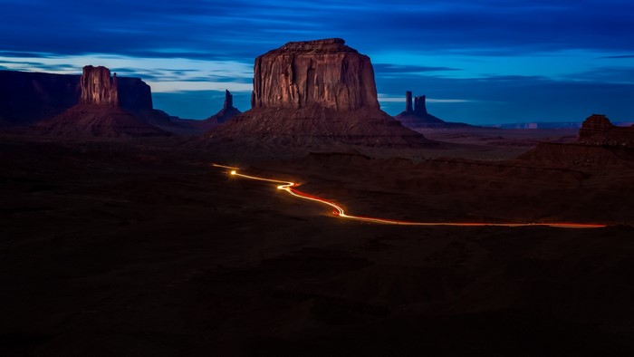Monument Valley long exposure at night with car light trails
