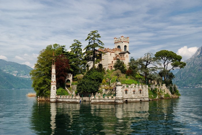 Castle on an island in a lake with mountains