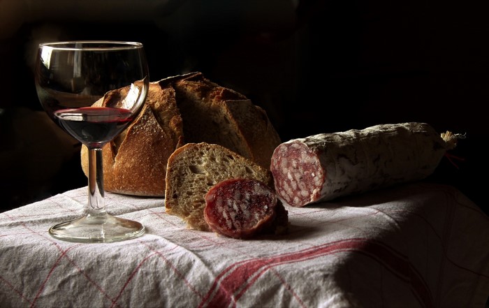 Still life with bread, wine, and sausage
