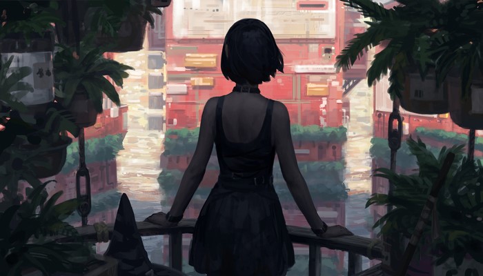 Woman with dark hair standing on a balcony overlooking a city