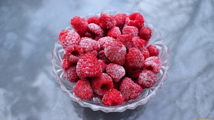 Frozen raspberries in a glass bowl