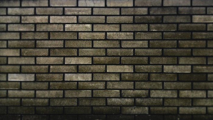 A close-up of a weathered brick wall texture