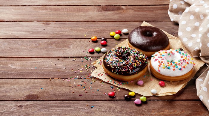 Donuts and candies on a wooden table