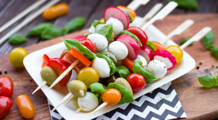 Colorful vegetable and mozzarella skewers on a plate