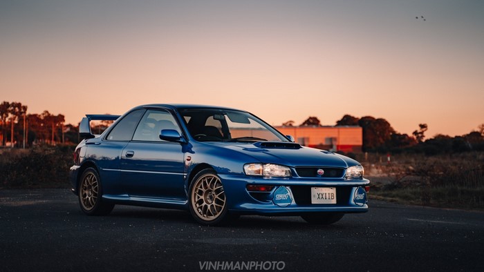 Blue Subaru Impreza WRX STi sports car at sunset