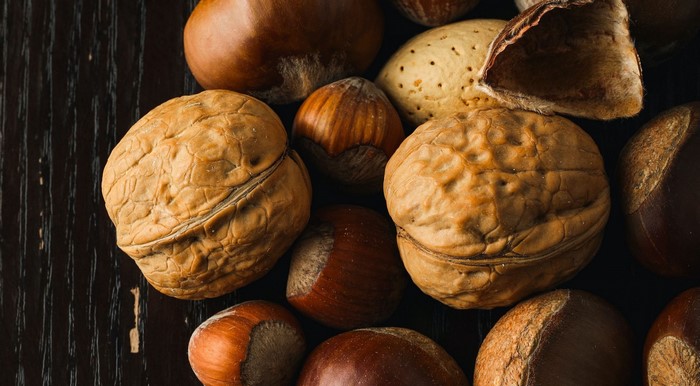 Assortment of nuts on a dark wooden surface