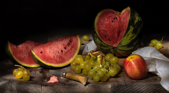Still life with watermelon, grapes, and apple