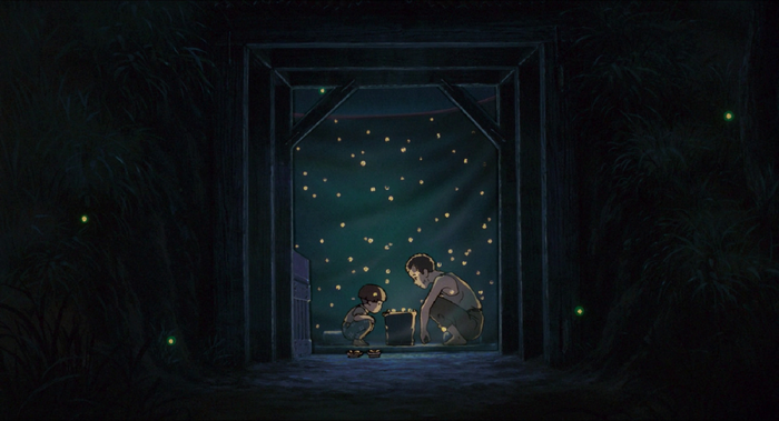 Two boys with fireflies in a dark structure