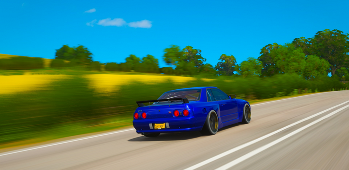 Blue Nissan Skyline GT-R R33 driving on a road in Forza Horizon 4