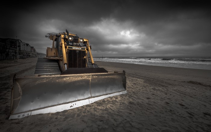 Yellow Caterpillar bulldozer on a sandy beach