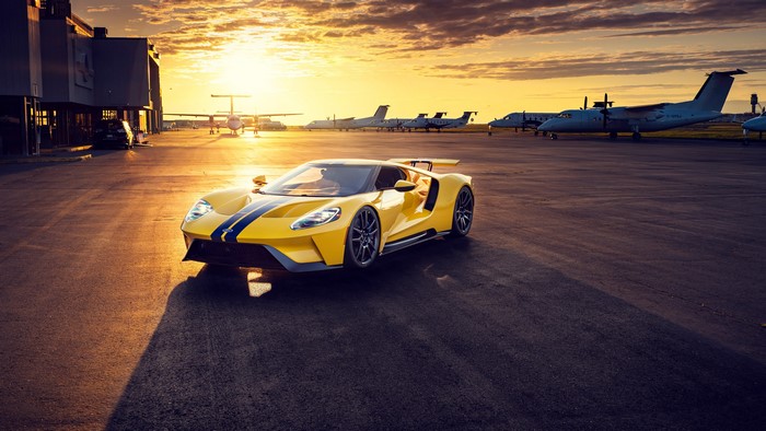 Yellow Ford GT Mk II on airport runway at sunset