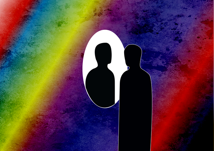 Silhouette in front of a rainbow mirror