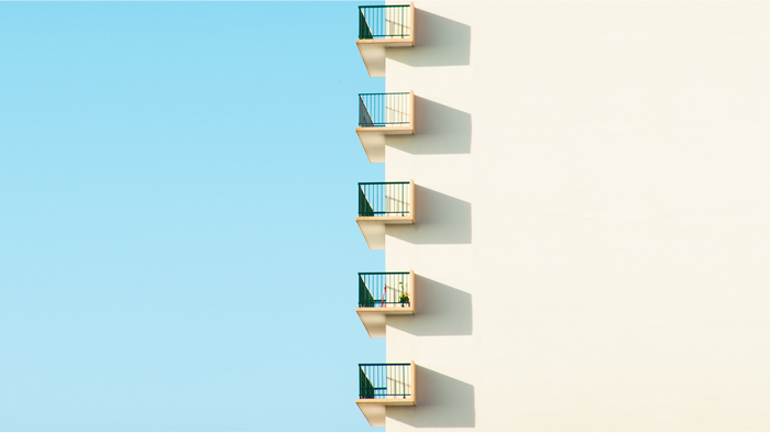 Balconies on a building against a blue sky