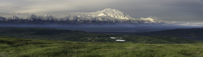Panorama of snowy mountain range over a valley