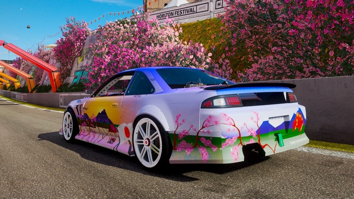 Nissan 240SX with Japanese-themed livery on a race track