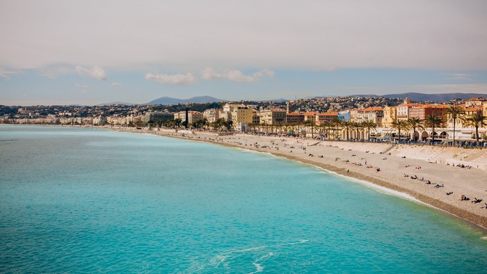 Beach in Nice, France with turquoise water and city skyline