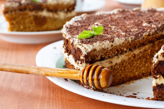 Chocolate cake with cream and honey dipper