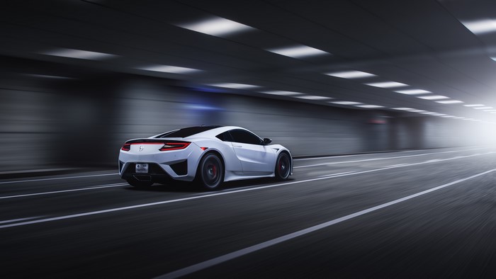 White Acura NSX driving through a tunnel
