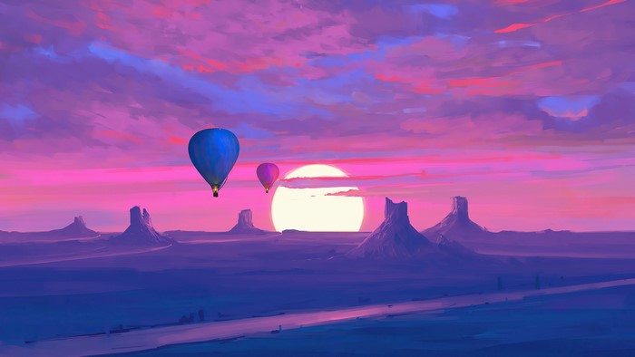 Hot air balloons over desert mountains at sunset