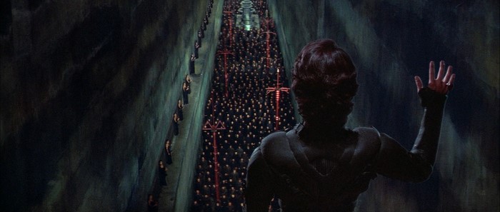 Woman observing a large gathering in Dune