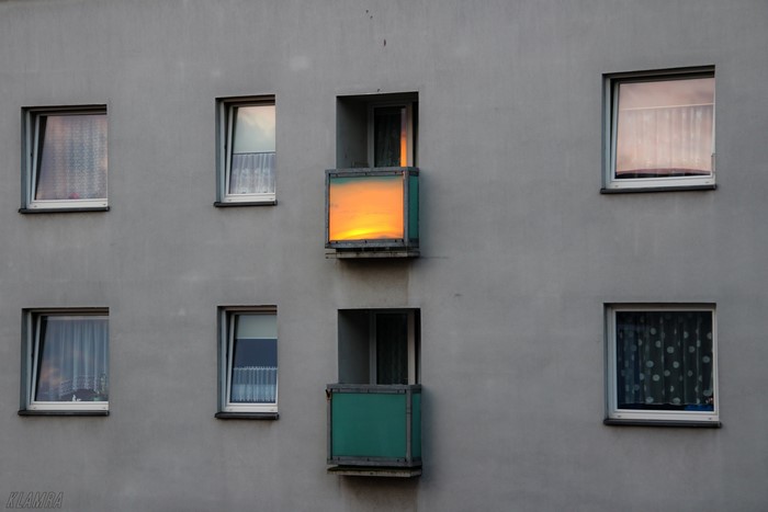 Apartment building balcony with sunrise reflection in Katowice, Poland