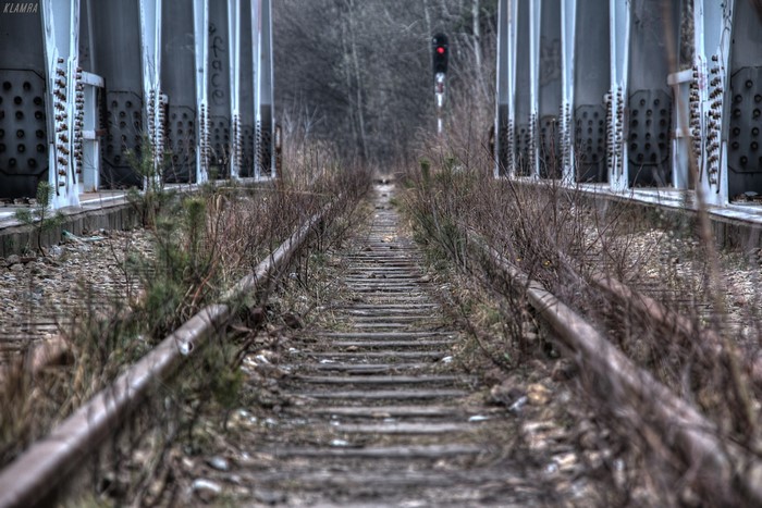 Abandoned railway tracks under a bridge in Katowice, Poland