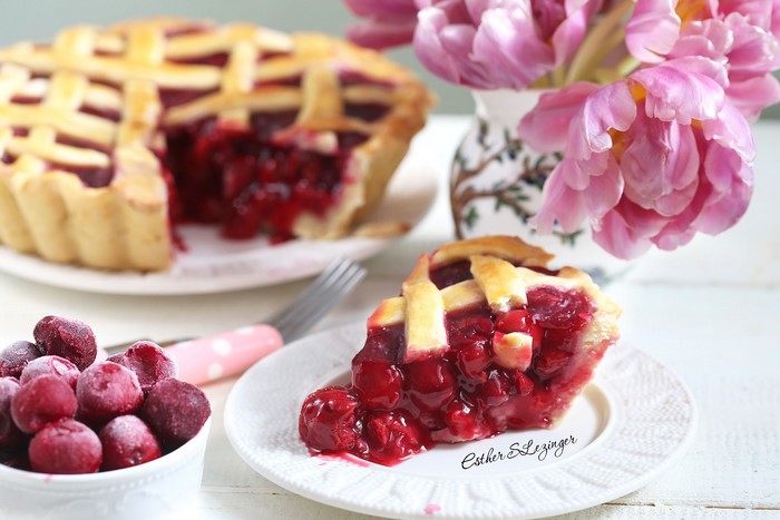 Cherry pie slice with frozen cherries and tulips
