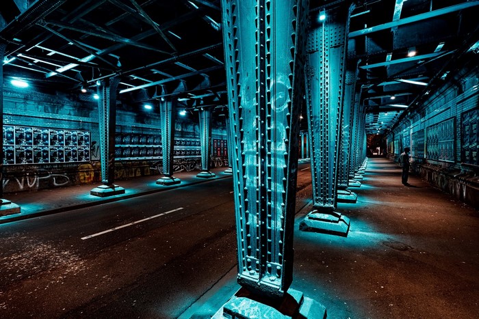 Urban underpass with cyan lighting in Cologne, Germany