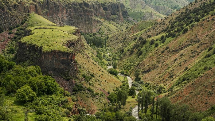 A winding river flows through a green gorge in Armenia