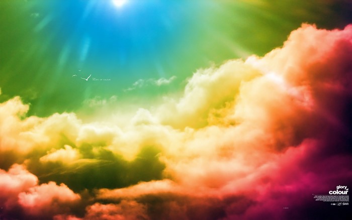 Colorful clouds with sun rays and birds