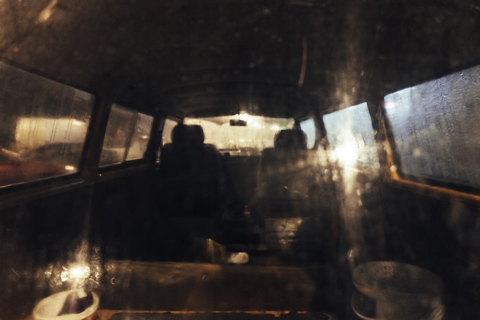 Interior of an old car at night with rain